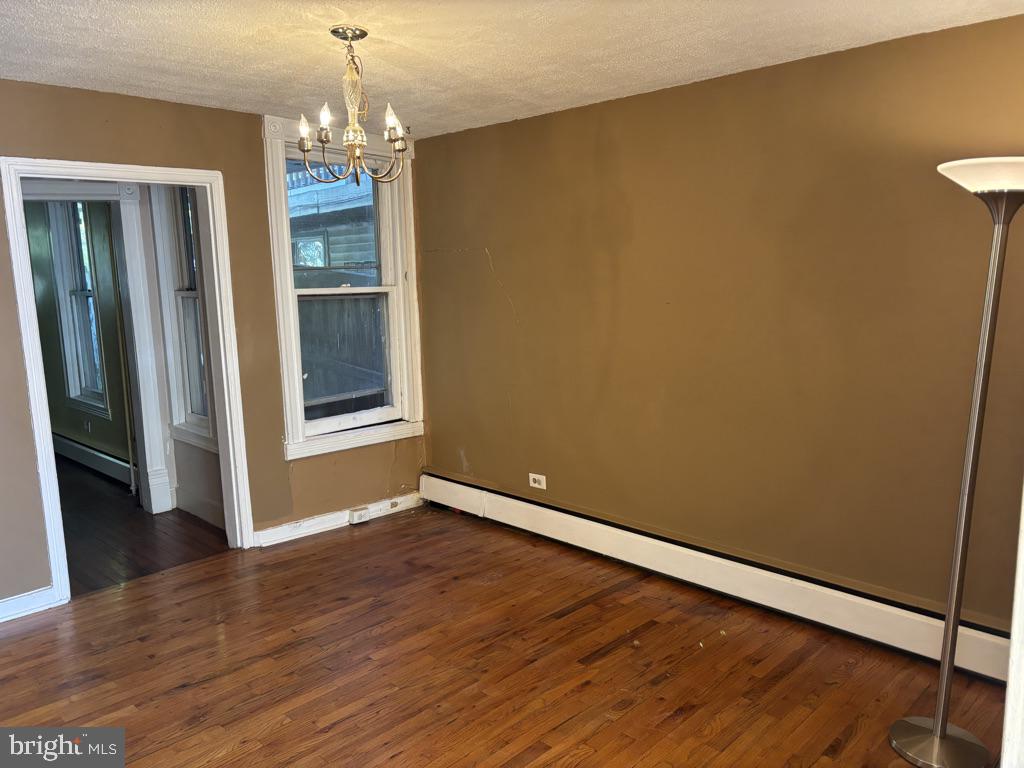121 East 4th Street Frederick, MD 21701 - Photo 4 of 21 an empty room with wooden floor and windows