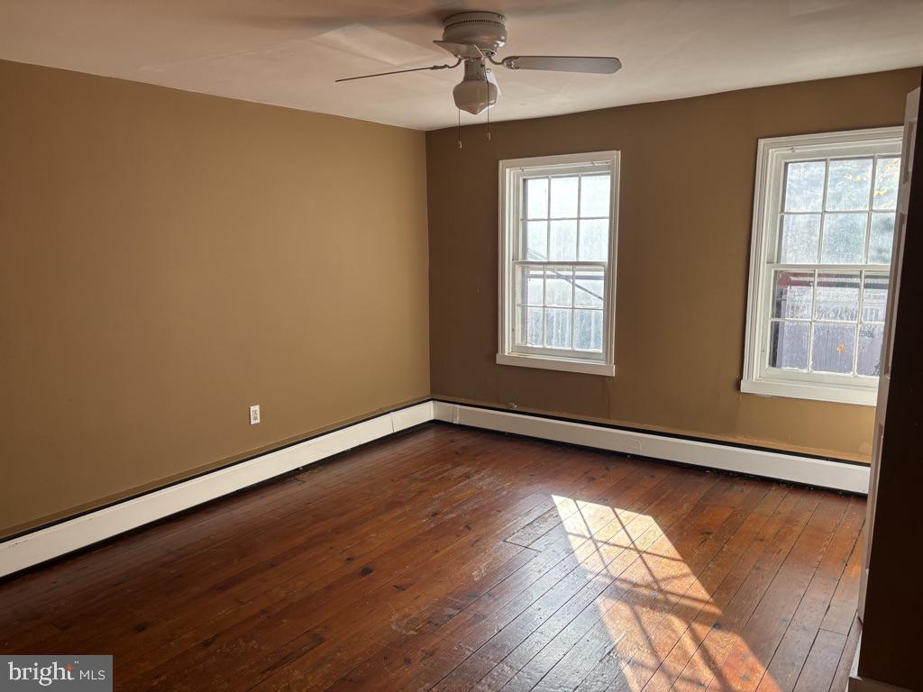 121 East 4th Street Frederick, MD 21701 - Photo 7 of 21 wooden floor in an empty room with a window