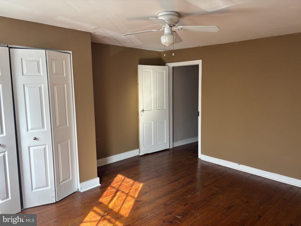 121 East 4th Street Frederick, MD 21701 - Photo 8 of 21 a view of an empty room with wooden floor and a ceiling fan
