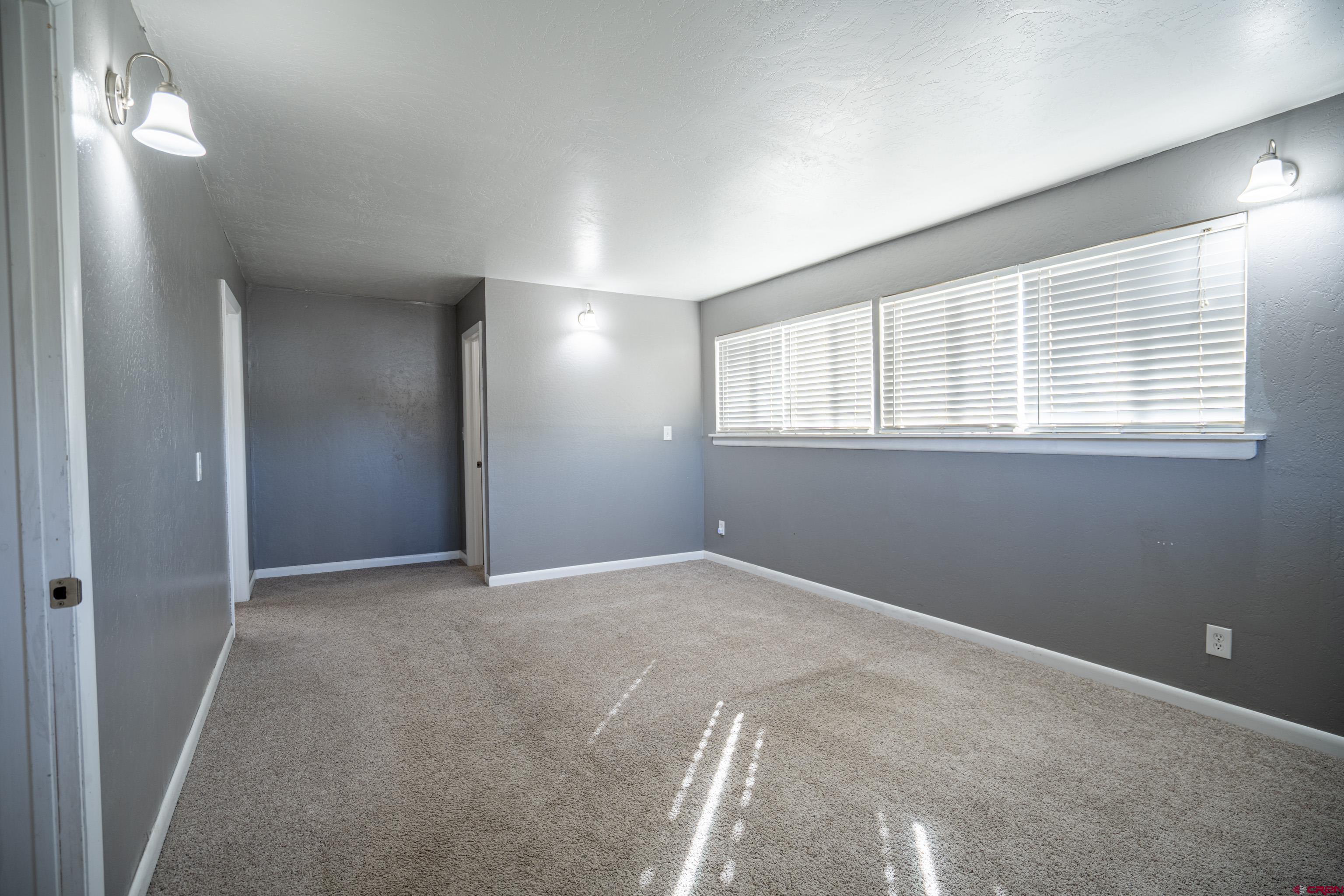 1702 East MacArthur Avenue Cortez, CO 81321 - Photo 12 of 42 a view of an empty room with a window