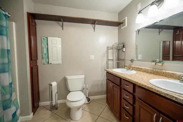 a open kitchen with kitchen island granite countertop a sink and a stove top oven