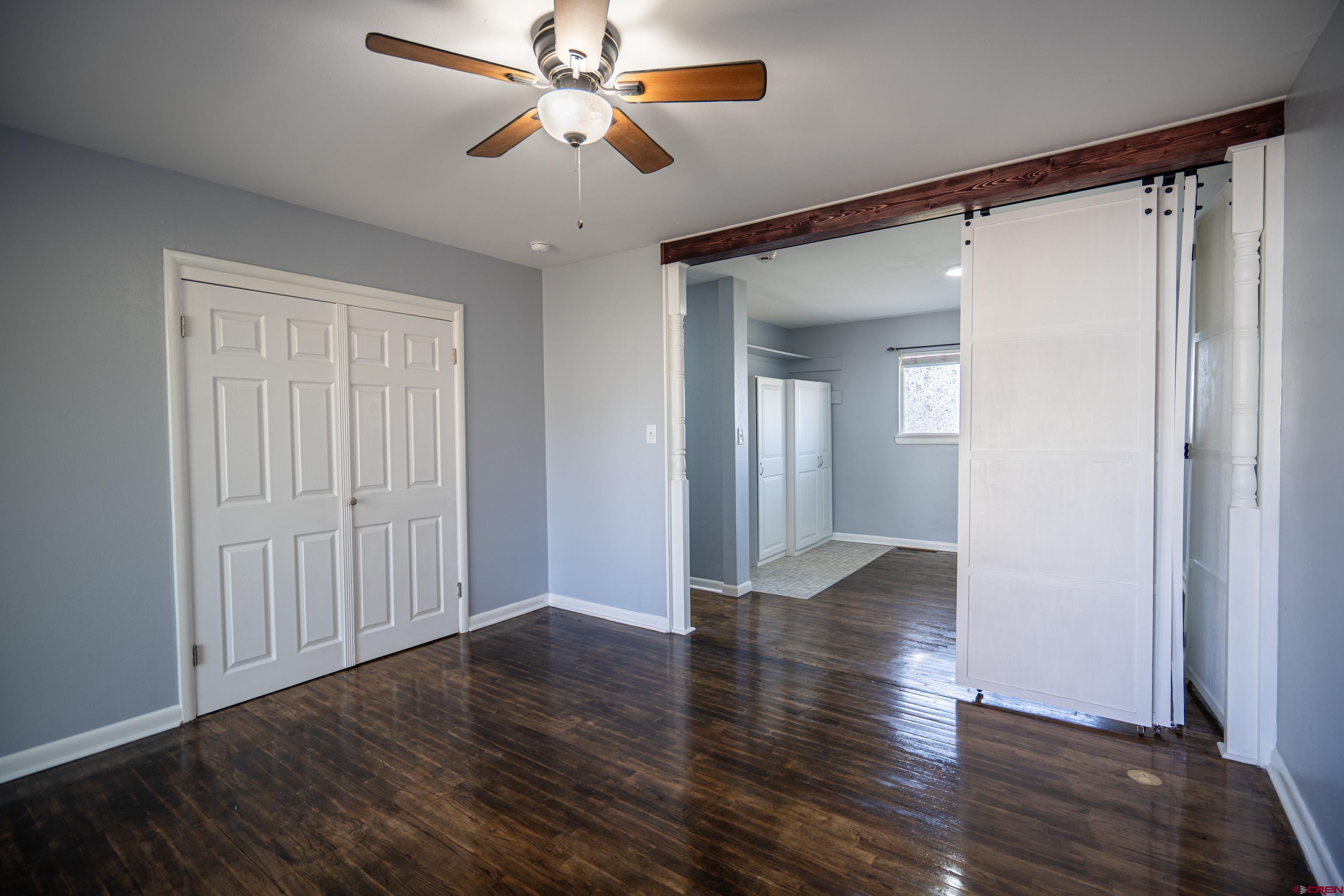 1702 East MacArthur Avenue Cortez, CO 81321 - Photo 24 of 42 wooden floor in an empty room with a window
