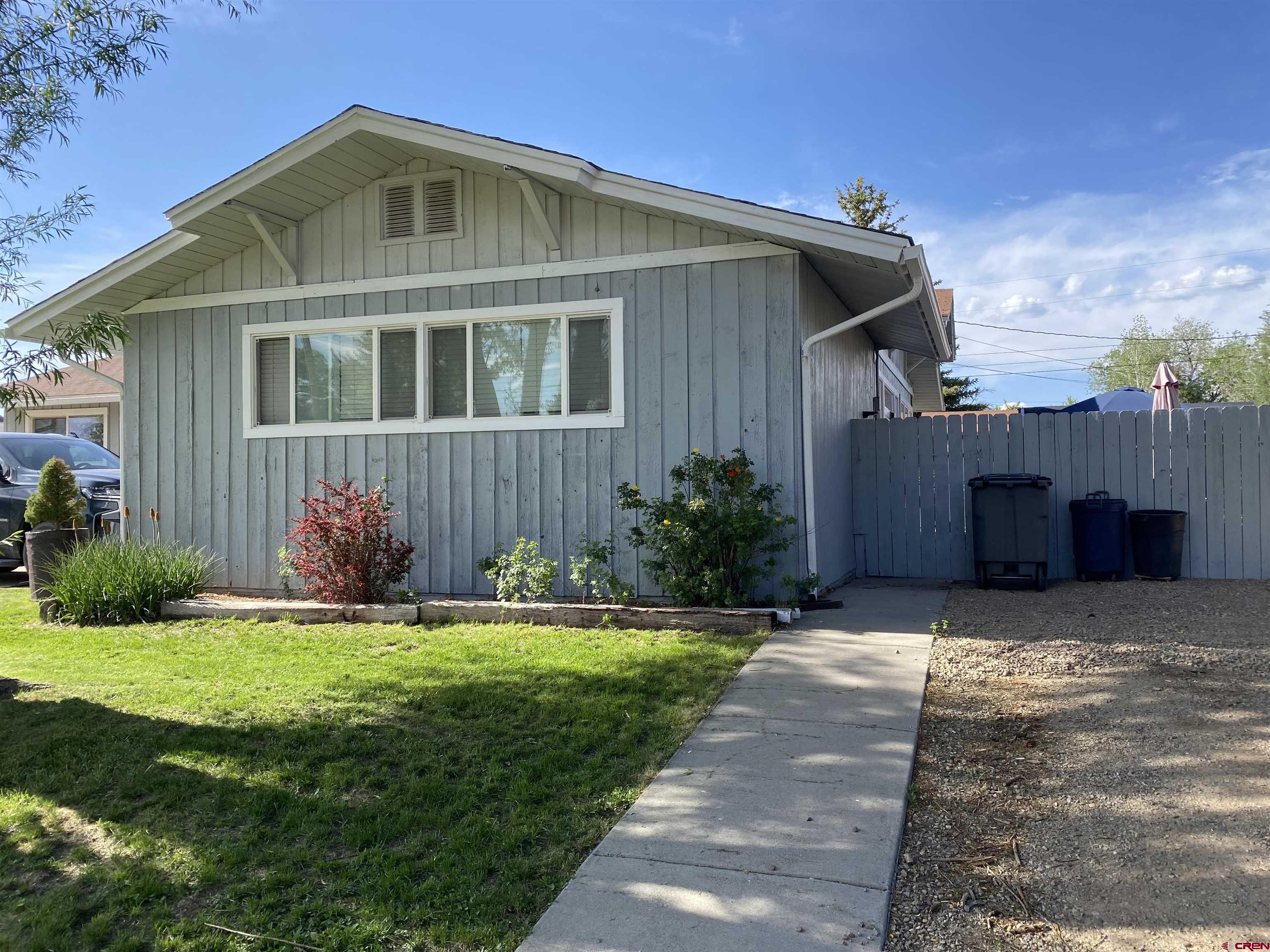 1702 East MacArthur Avenue Cortez, CO 81321 - Photo 41 of 42 a front view of a house with a yard and garage