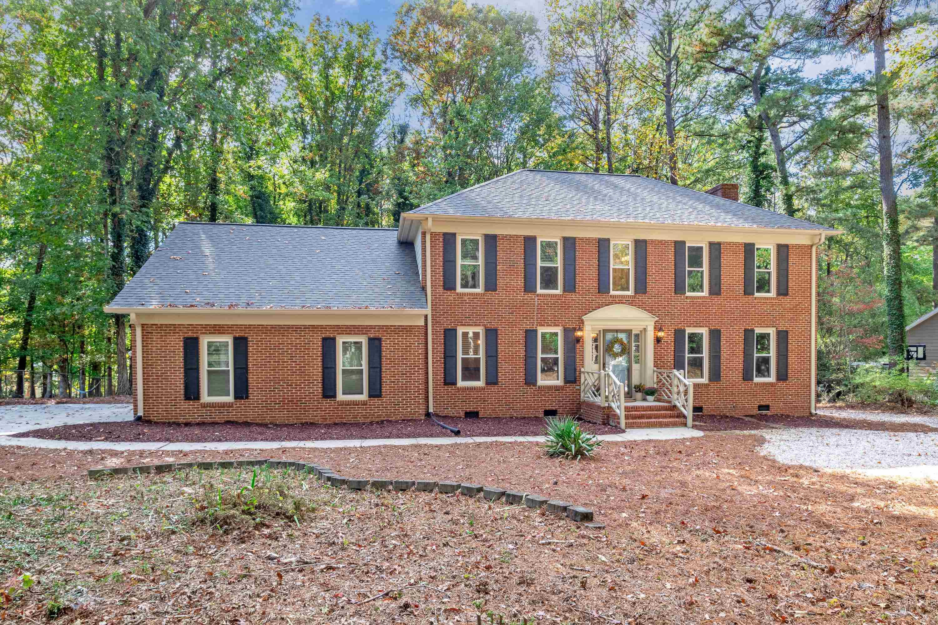 10213 Bushveld Lane Raleigh, NC 27613 - Photo 1 of 62 a front view of a house with garden