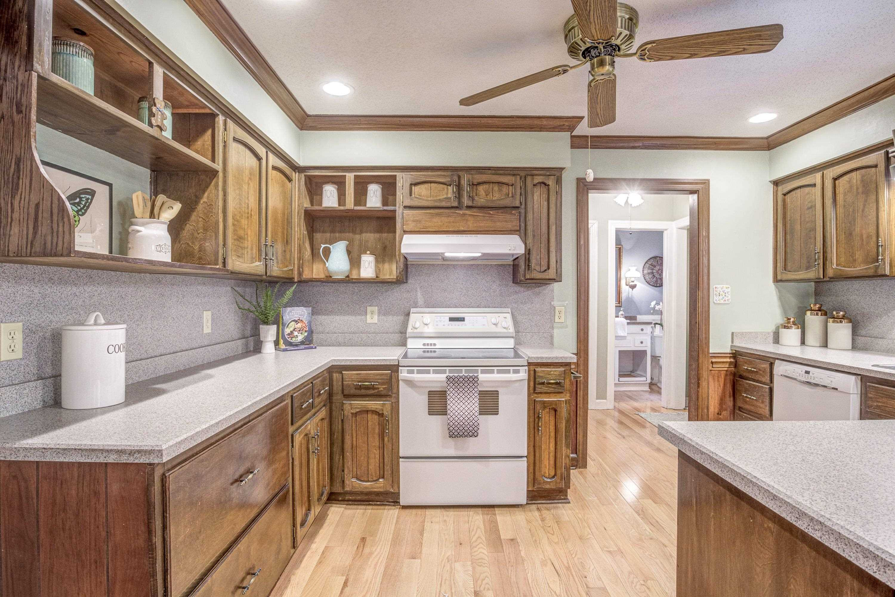 10213 Bushveld Lane Raleigh, NC 27613 - Photo 22 of 62 a kitchen with a stove top oven sink and cabinets