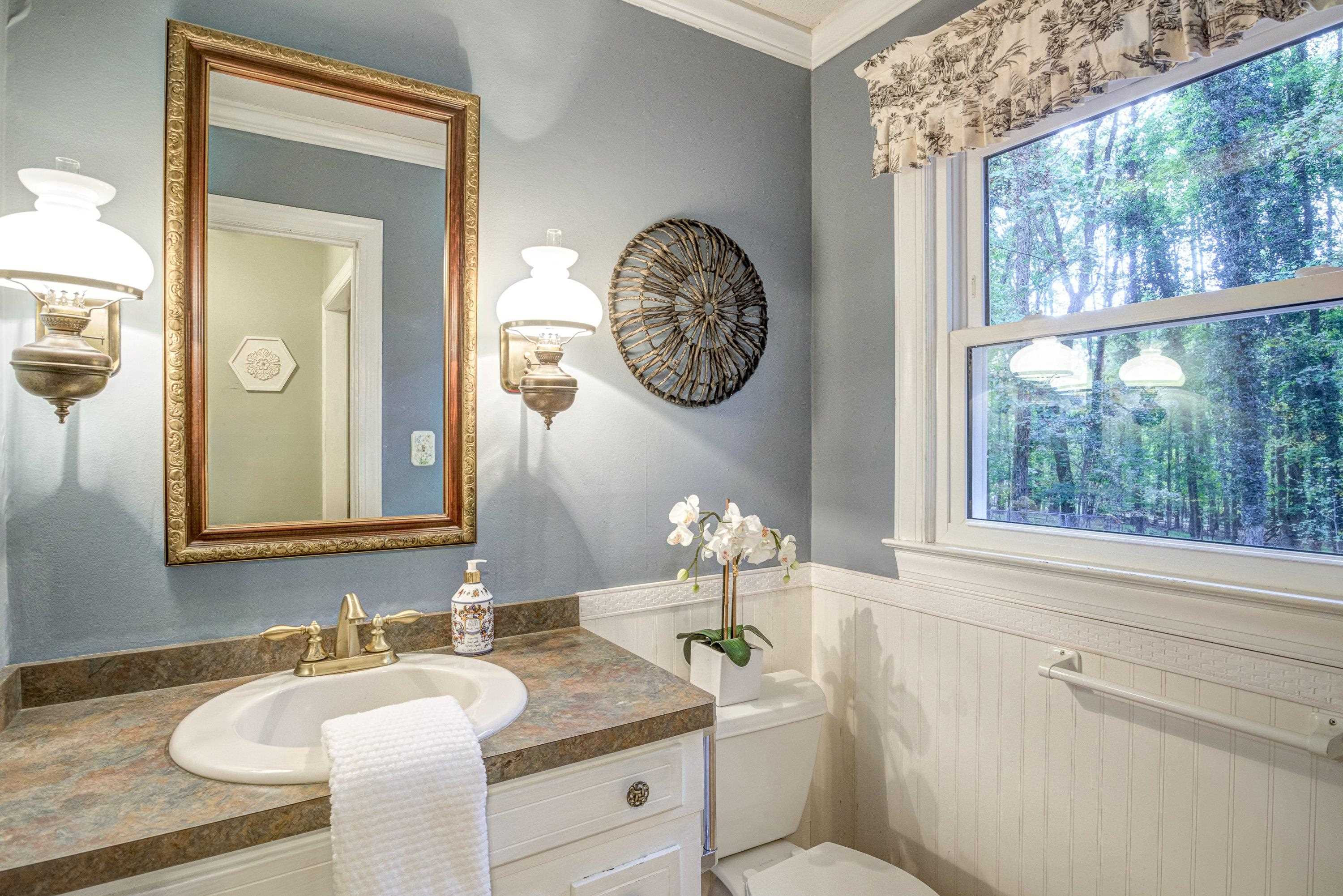 10213 Bushveld Lane Raleigh, NC 27613 - Photo 31 of 62 a bathroom with a granite countertop sink mirror vanity and a toilet