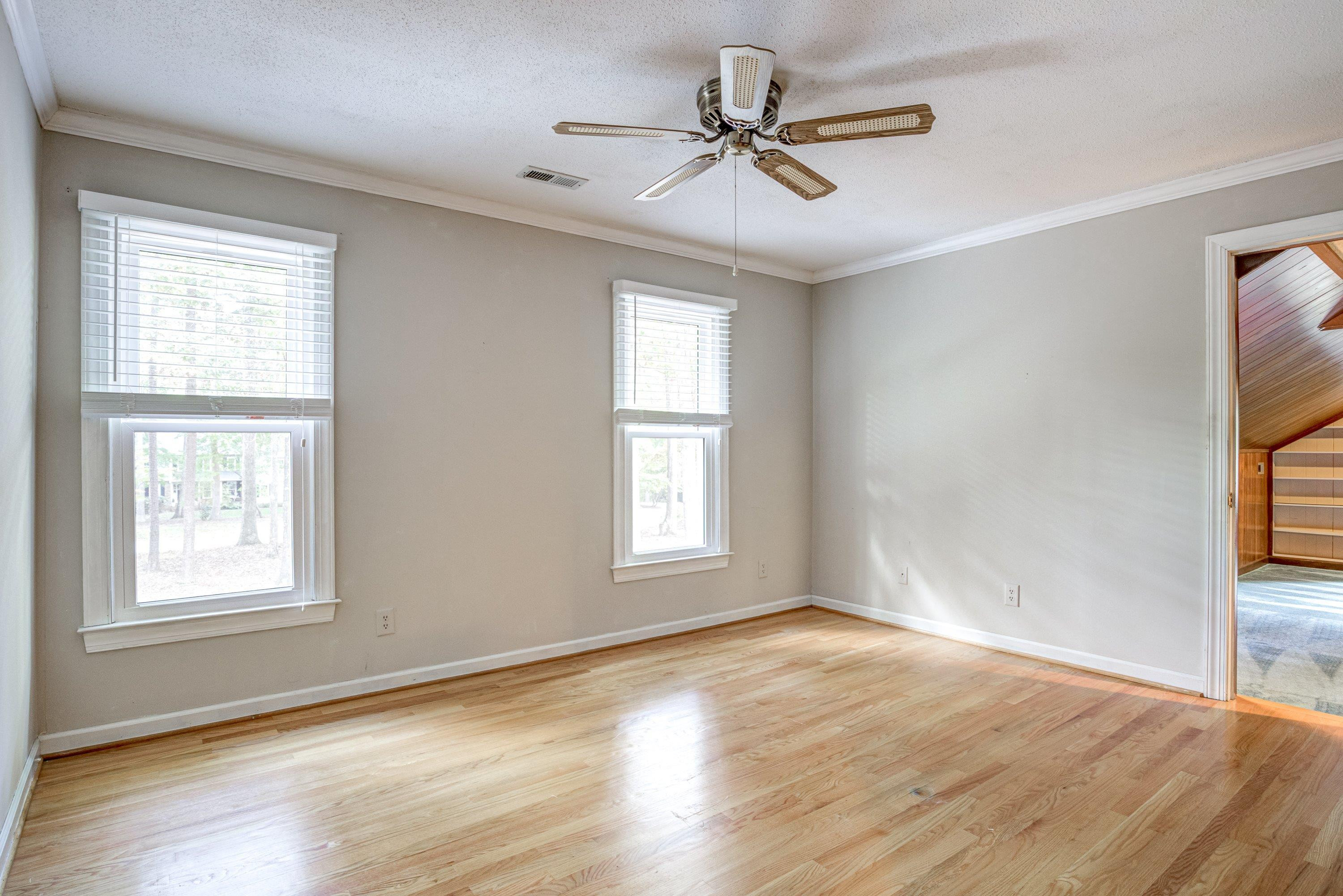 10213 Bushveld Lane Raleigh, NC 27613 - Photo 32 of 62 a view of an empty room with wooden floor and a window