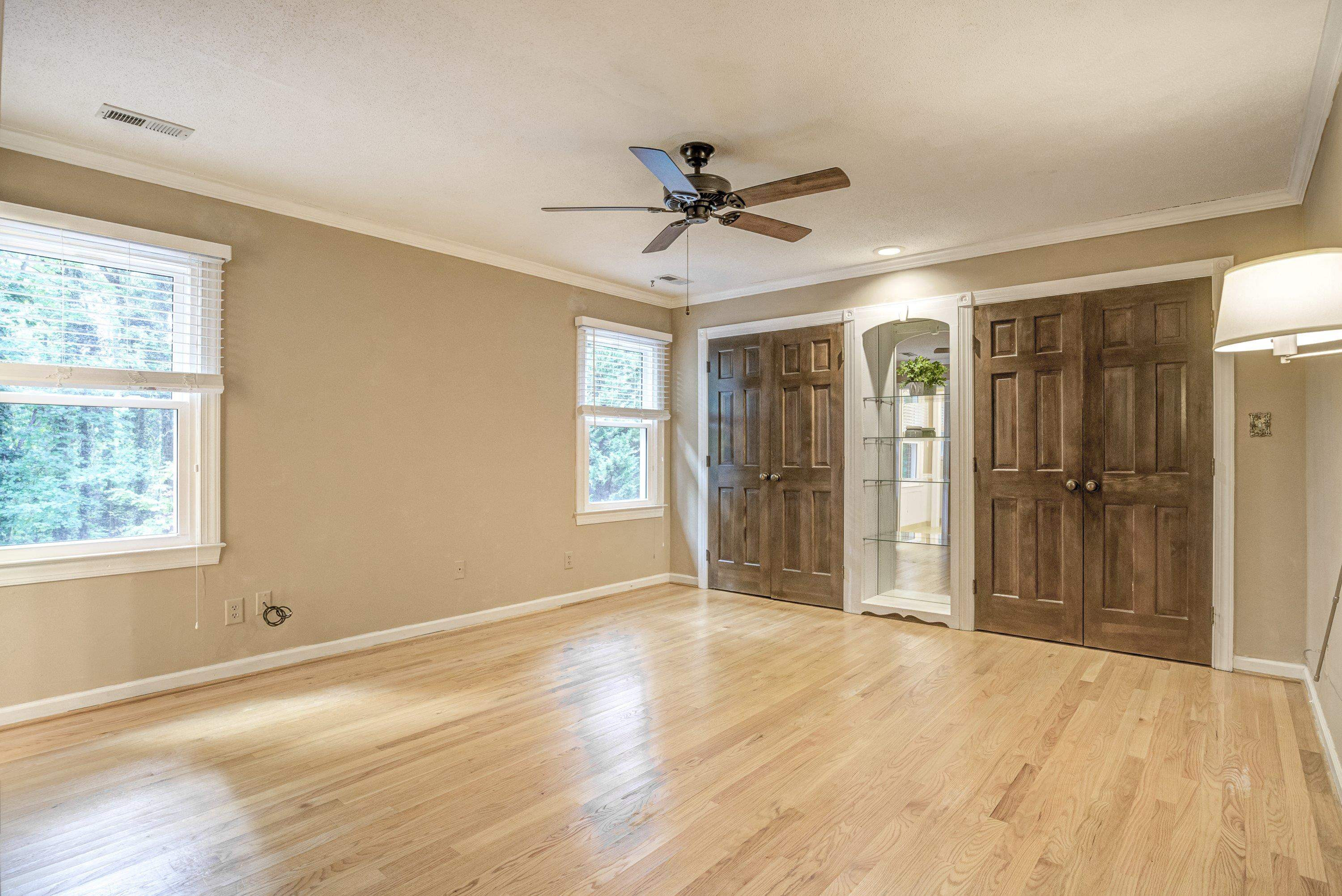 10213 Bushveld Lane Raleigh, NC 27613 - Photo 38 of 62 a view of a livingroom with a chandelier fan and windows