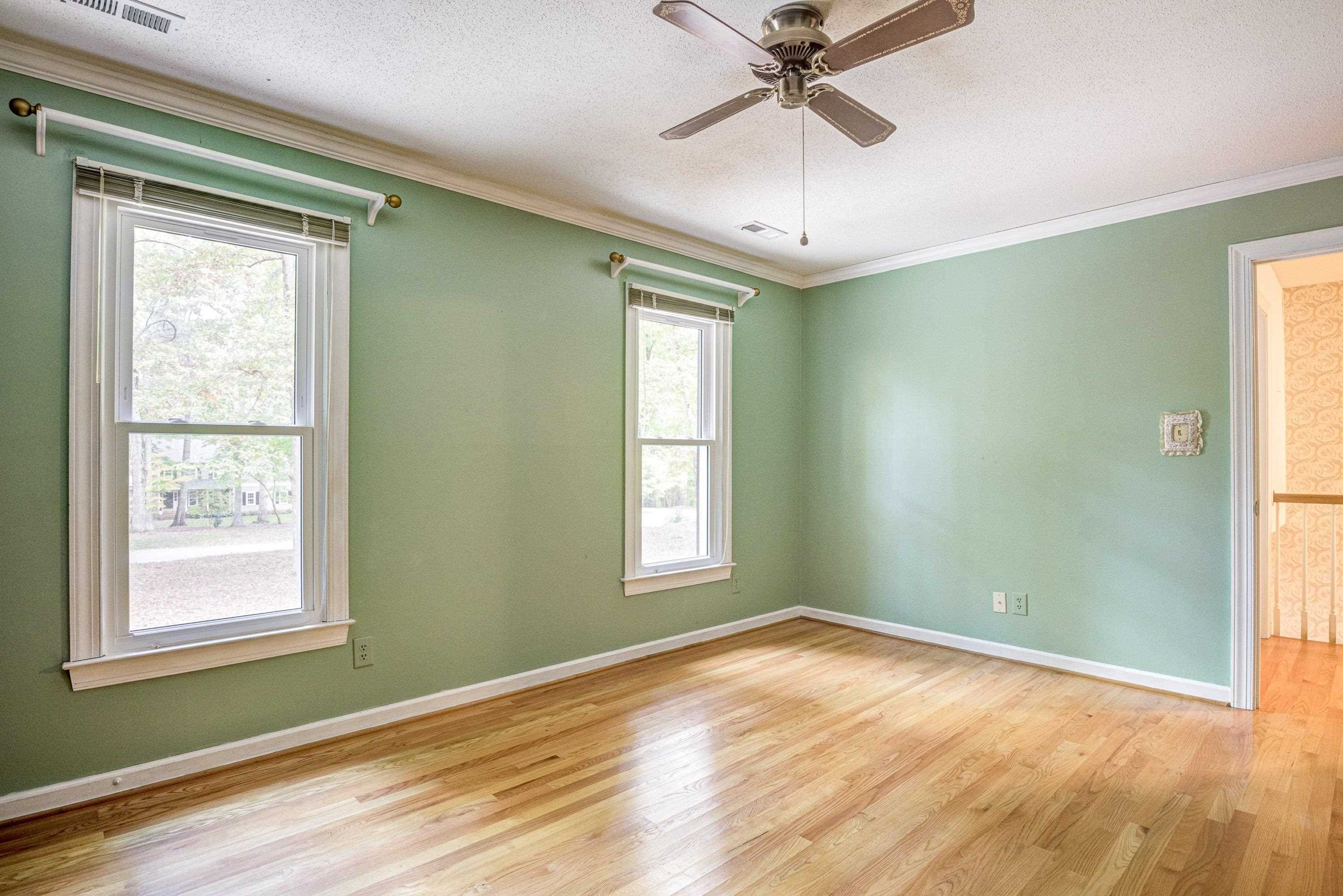 10213 Bushveld Lane Raleigh, NC 27613 - Photo 44 of 62 a view of empty room with wooden floor and fan