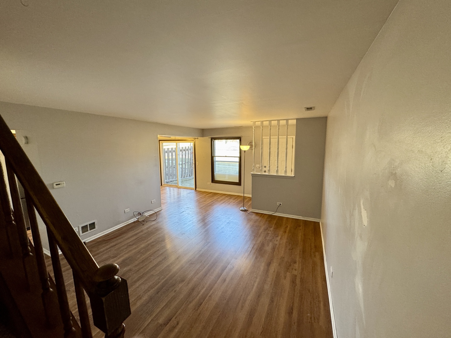 412 St Johns Road, Unit D Woodstock, IL 60098 - Photo 13 of 19 wooden floor in an empty room with a window