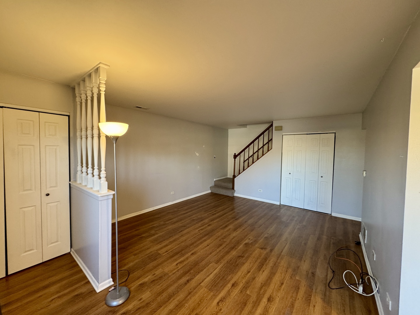 412 St Johns Road, Unit D Woodstock, IL 60098 - Photo 14 of 19 a view of an empty room with wooden floor and a hallway