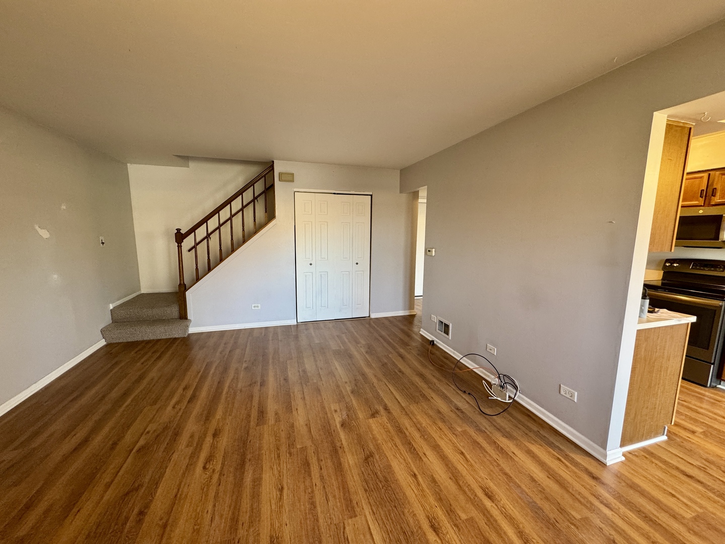 412 St Johns Road, Unit D Woodstock, IL 60098 - Photo 3 of 19 a view of a room with wooden floor and staircase