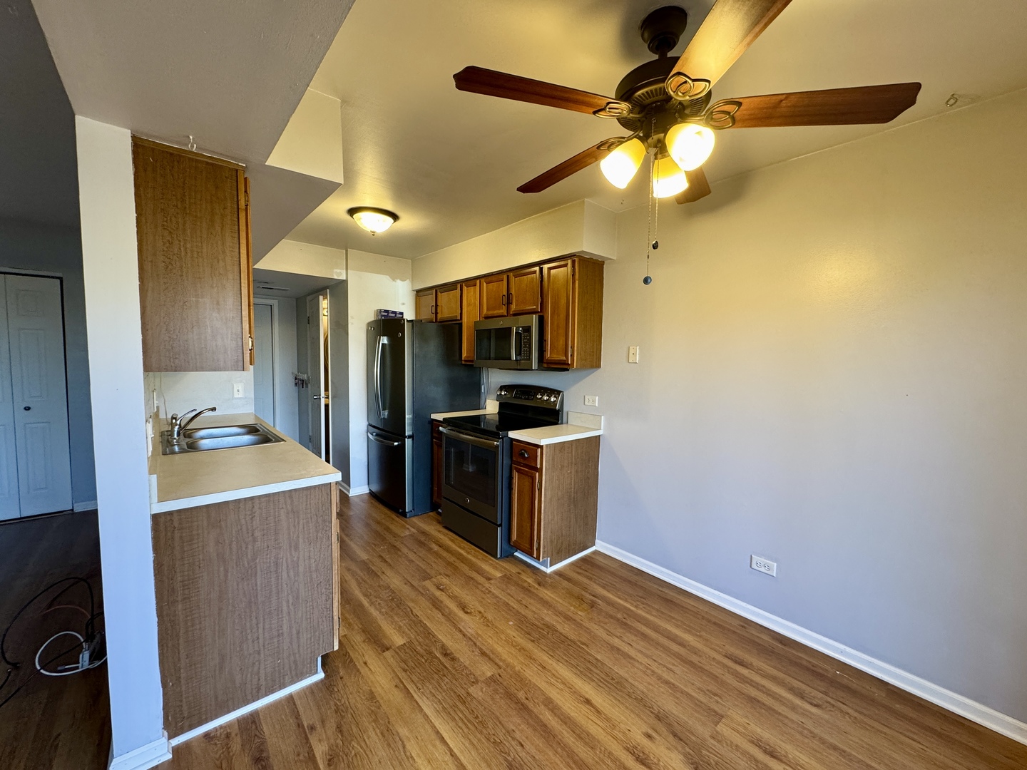 412 St Johns Road, Unit D Woodstock, IL 60098 - Photo 5 of 19 a kitchen with granite countertop a sink cabinets and stainless steel appliances
