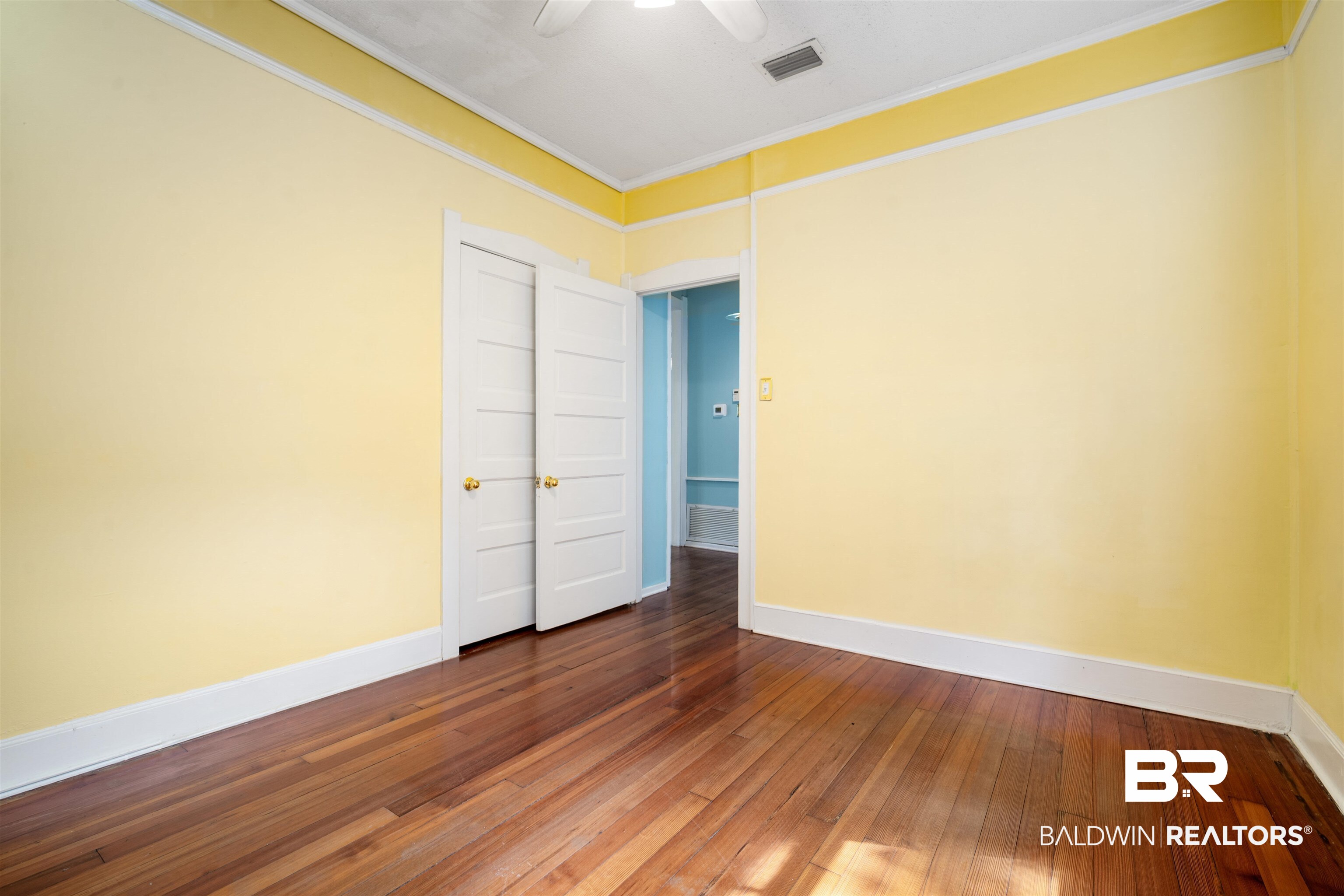 118 Mohawk Street Mobile, AL 36606 - Photo 16 of 26 Unfurnished room with crown molding and dark wood-style flooring