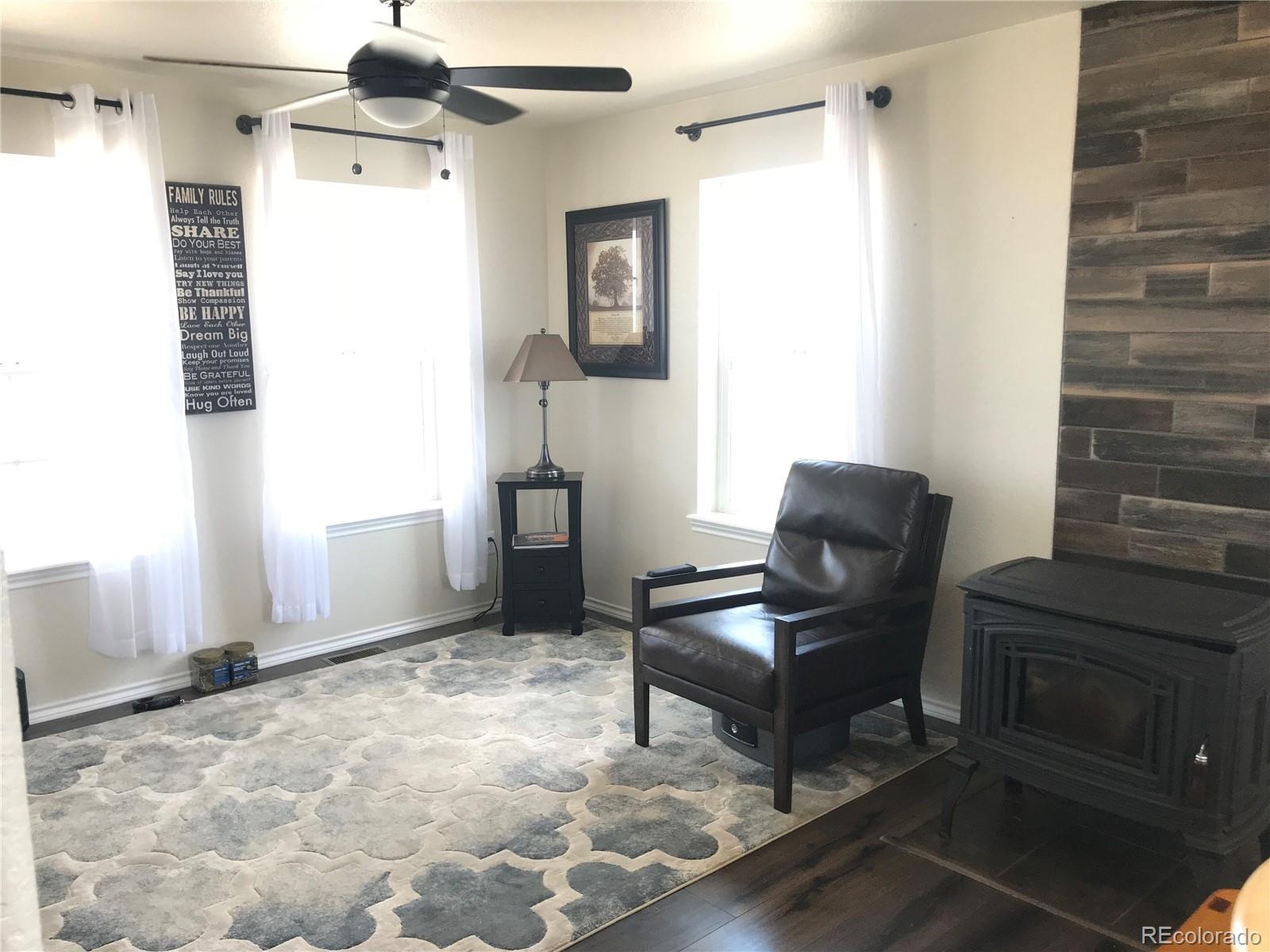 9345 North Log Road Calhan, CO 80808 - Photo 5 of 23 a living room with furniture and a fireplace