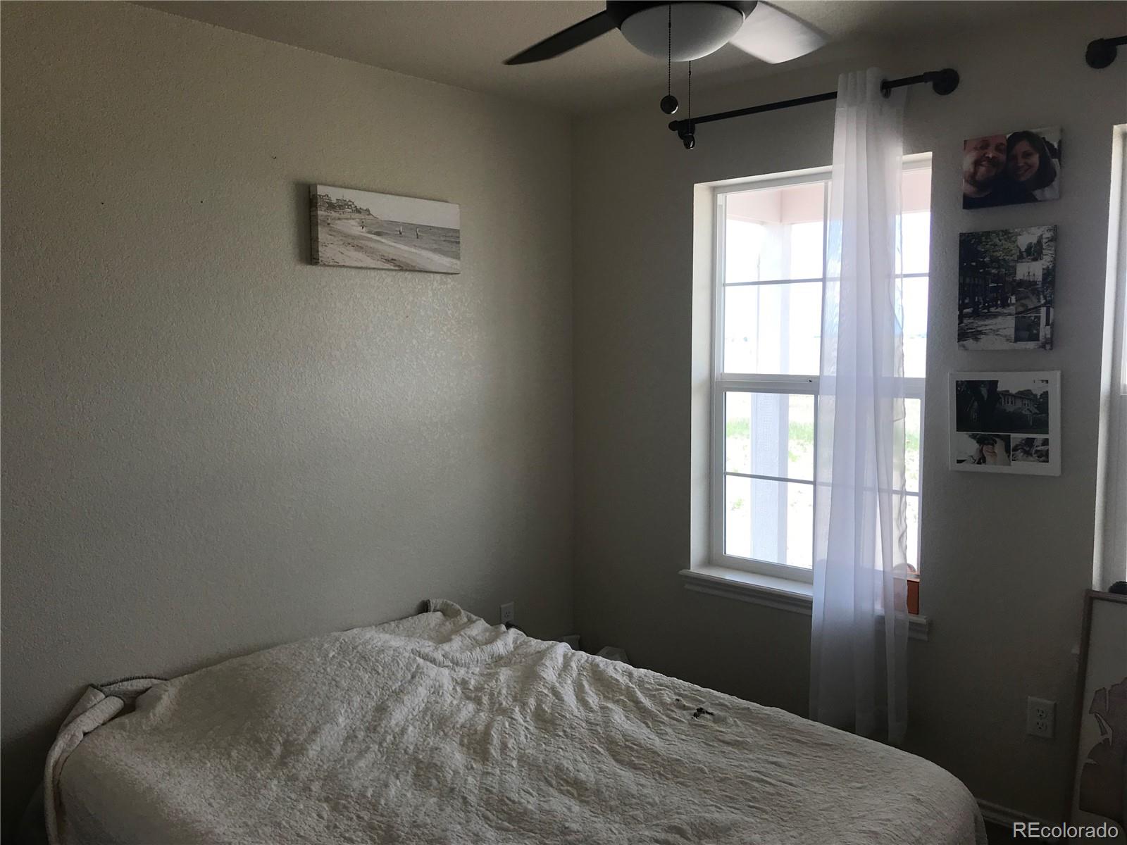 9345 North Log Road Calhan, CO 80808 - Photo 8 of 23 a bedroom with a bed and a window