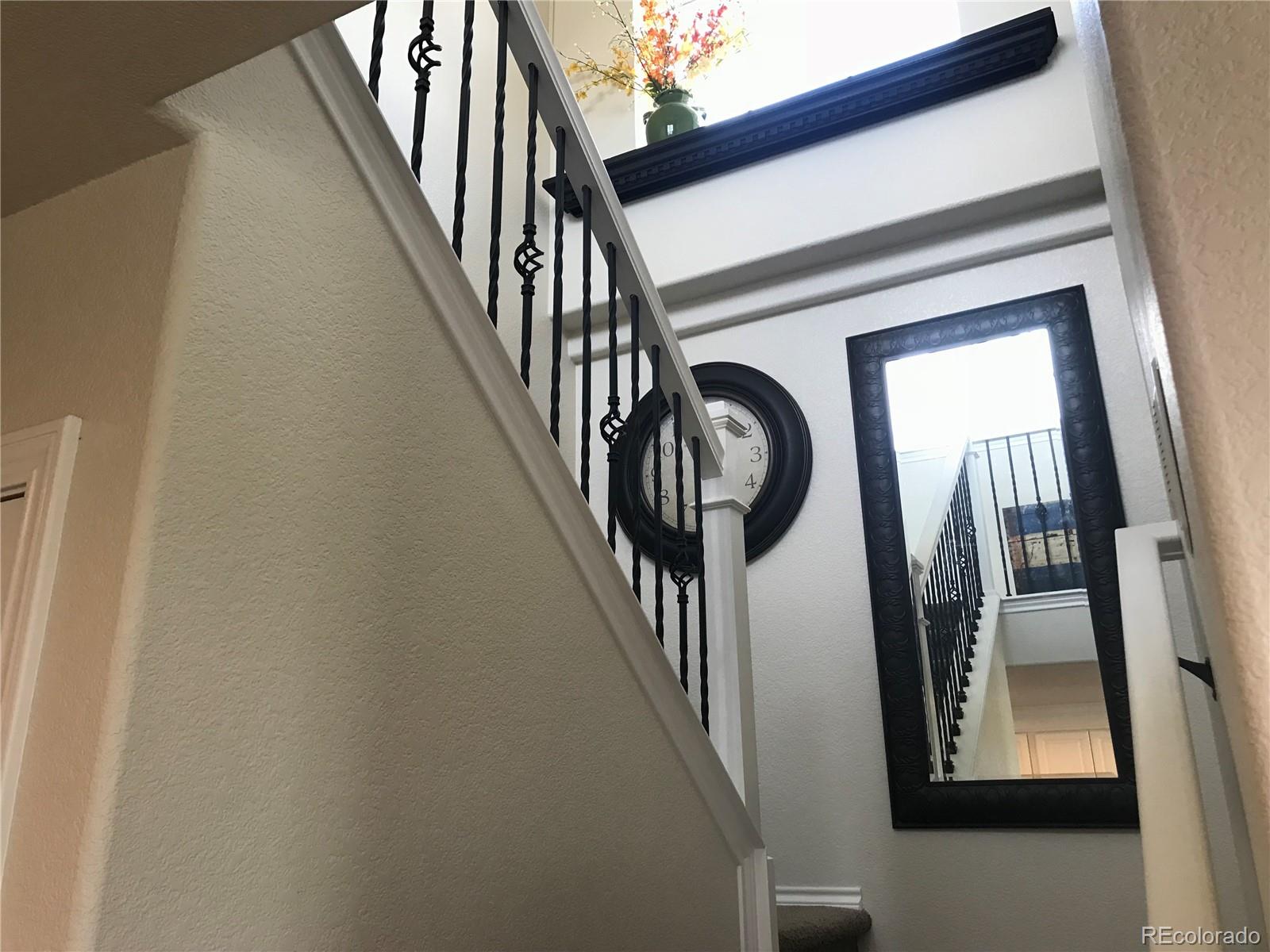 9345 North Log Road Calhan, CO 80808 - Photo 10 of 23 a view of staircase with railing and white walls