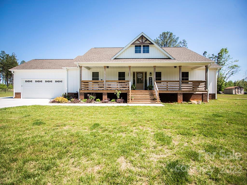 1350 Miles Road Dallas, NC 28034 - Photo 1 of 17 a front view of a house with a garden