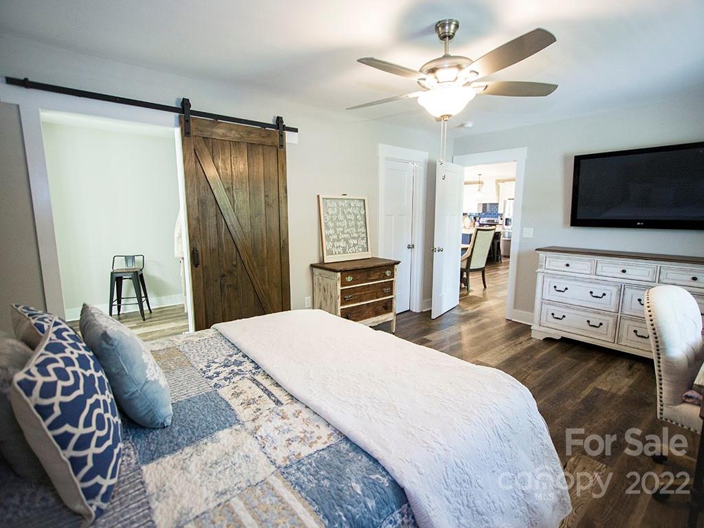 1350 Miles Road Dallas, NC 28034 - Photo 13 of 17 a bedroom with a bed and a flat screen tv
