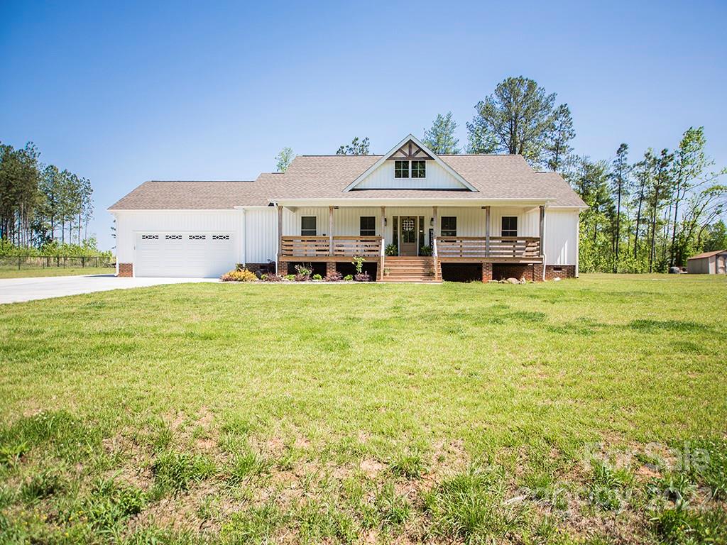 1350 Miles Road Dallas, NC 28034 - Photo 3 of 17 a big house with tall trees in front of it