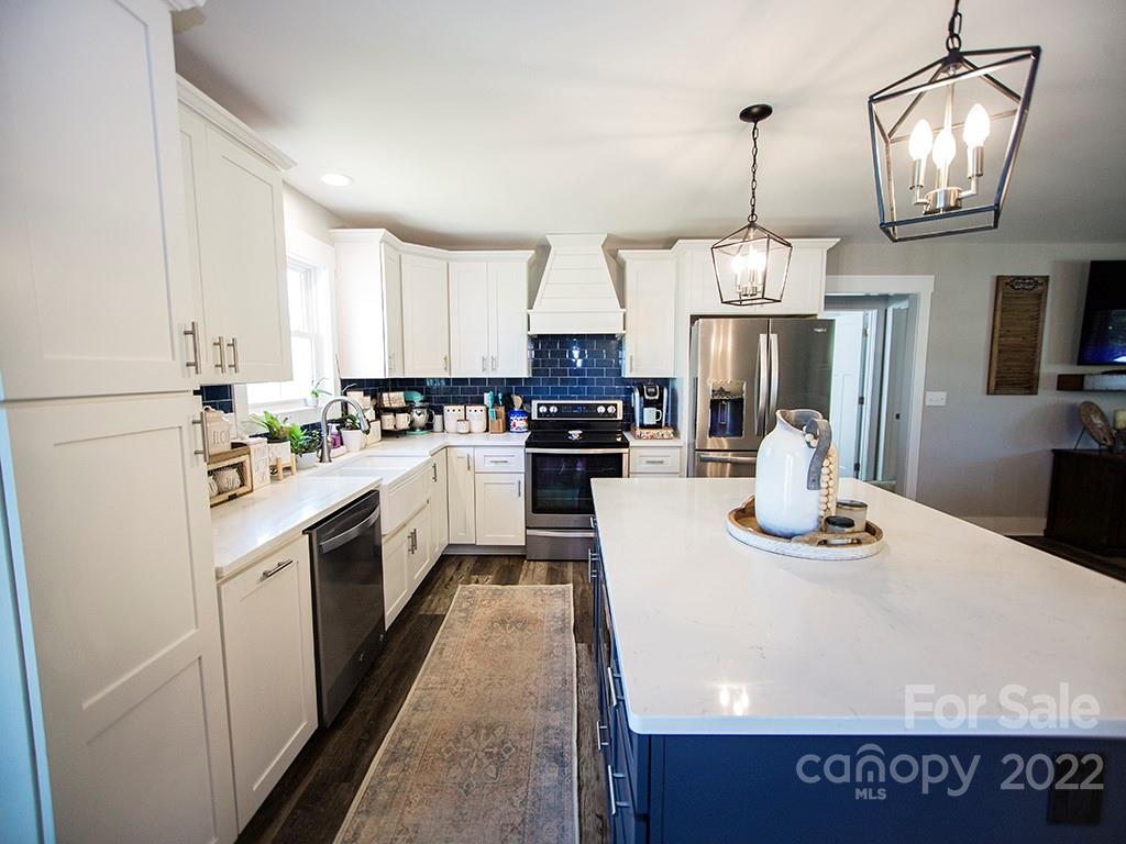 1350 Miles Road Dallas, NC 28034 - Photo 8 of 17 a kitchen with stainless steel appliances granite countertop a sink a stove and a refrigerator