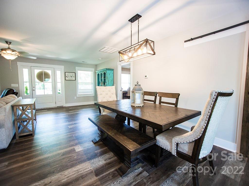 1350 Miles Road Dallas, NC 28034 - Photo 9 of 17 a view of a dining room with furniture wooden floor and chandelier