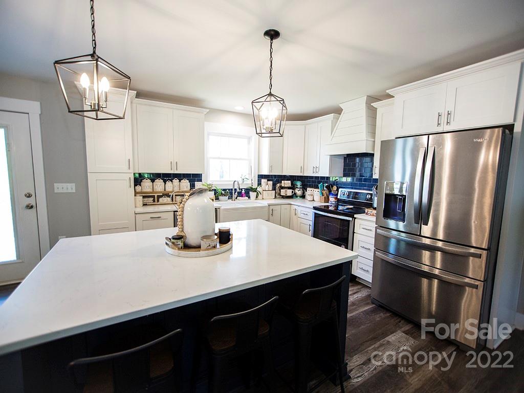 1350 Miles Road Dallas, NC 28034 - Photo 10 of 17 a kitchen with refrigerator cabinets and wooden floor