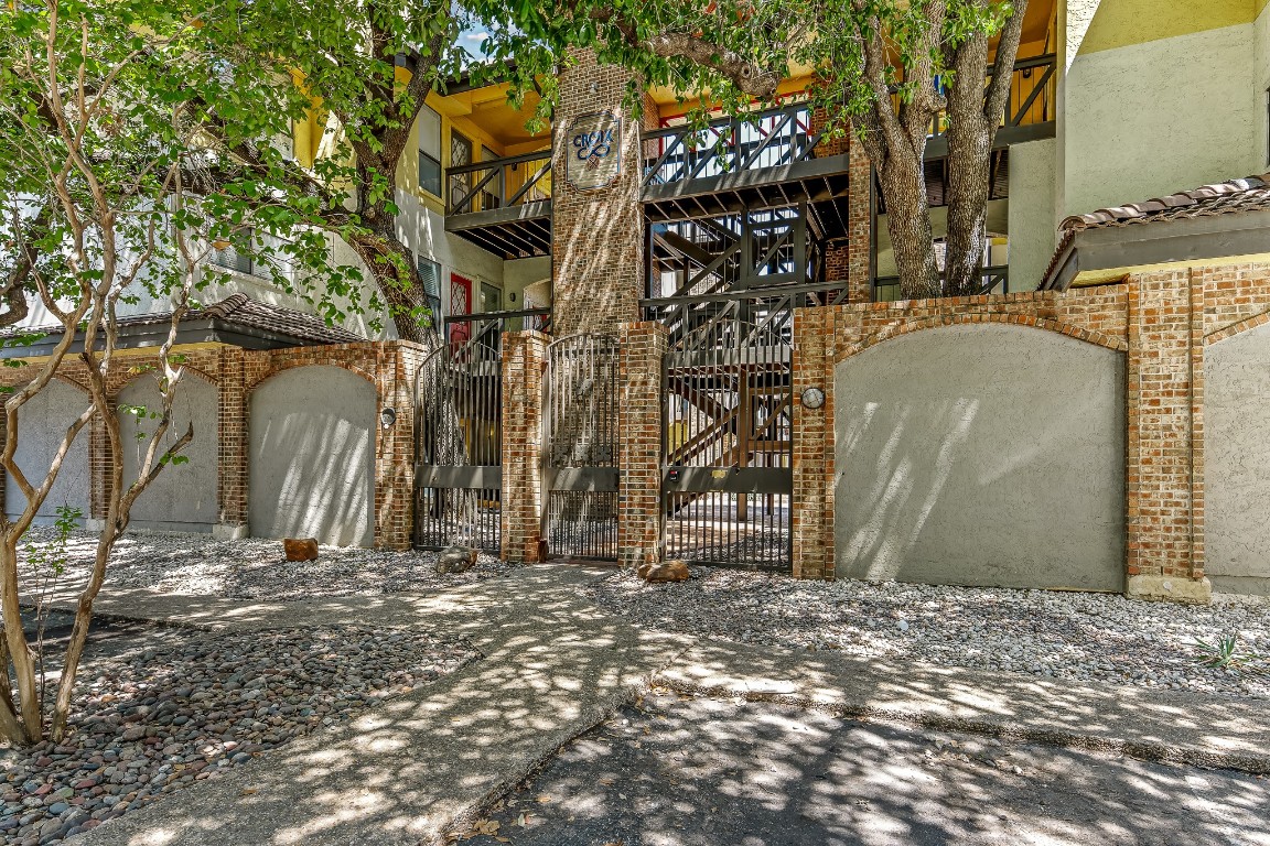 806 West 24th Street, Unit 214 Austin, TX 78705 - Photo 1 of 1 a backyard of a building with large trees