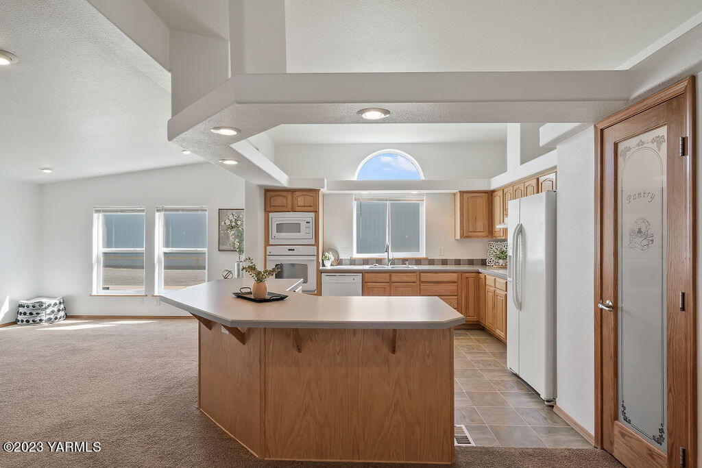 1305 Faucher Road Moxee, WA 98936 - Photo 12 of 40 a dining hall with stainless steel appliances granite countertop a refrigerator and a sink