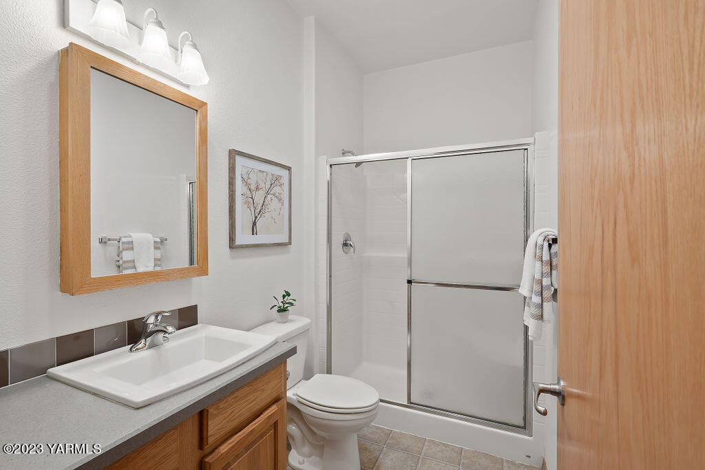 1305 Faucher Road Moxee, WA 98936 - Photo 20 of 40 a white toilet sitting next to a bathroom sink