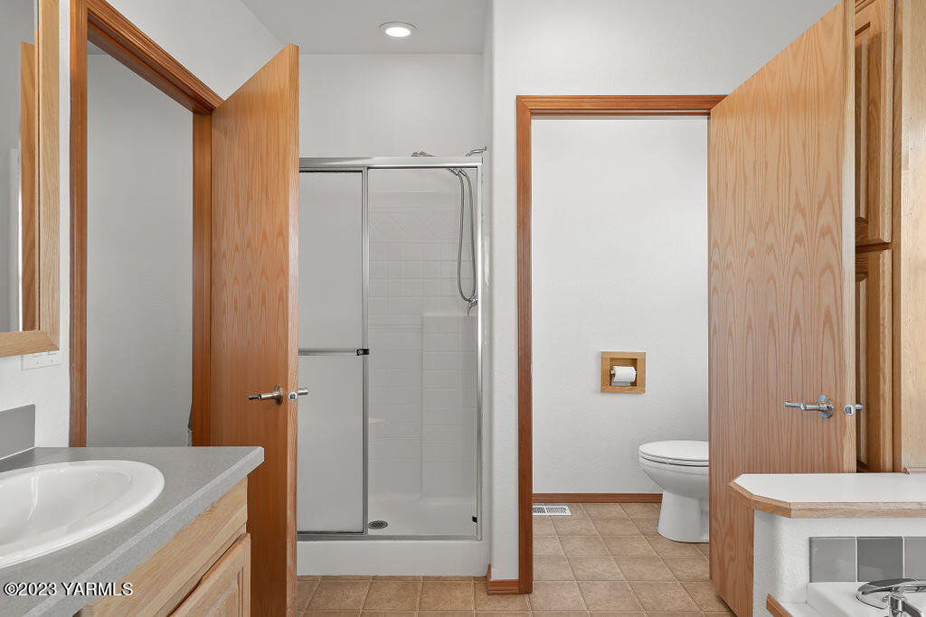 1305 Faucher Road Moxee, WA 98936 - Photo 26 of 40 a bathroom with a granite countertop sink toilet and shower