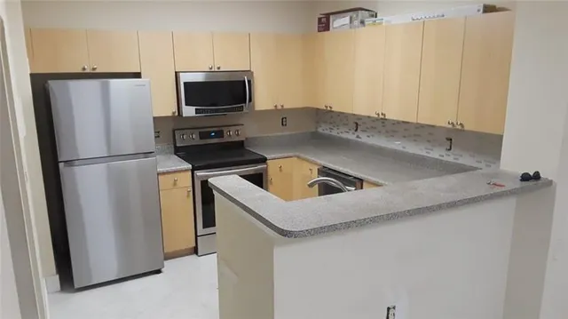 a kitchen with a refrigerator sink and microwave