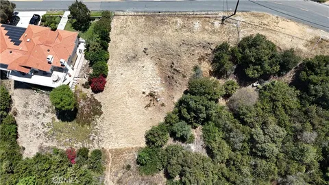 an aerial view of a house with a yard and garden