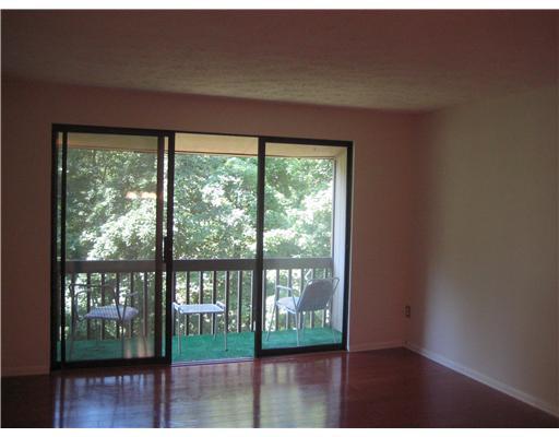 Living Room. Living room has private balcony with wooded view