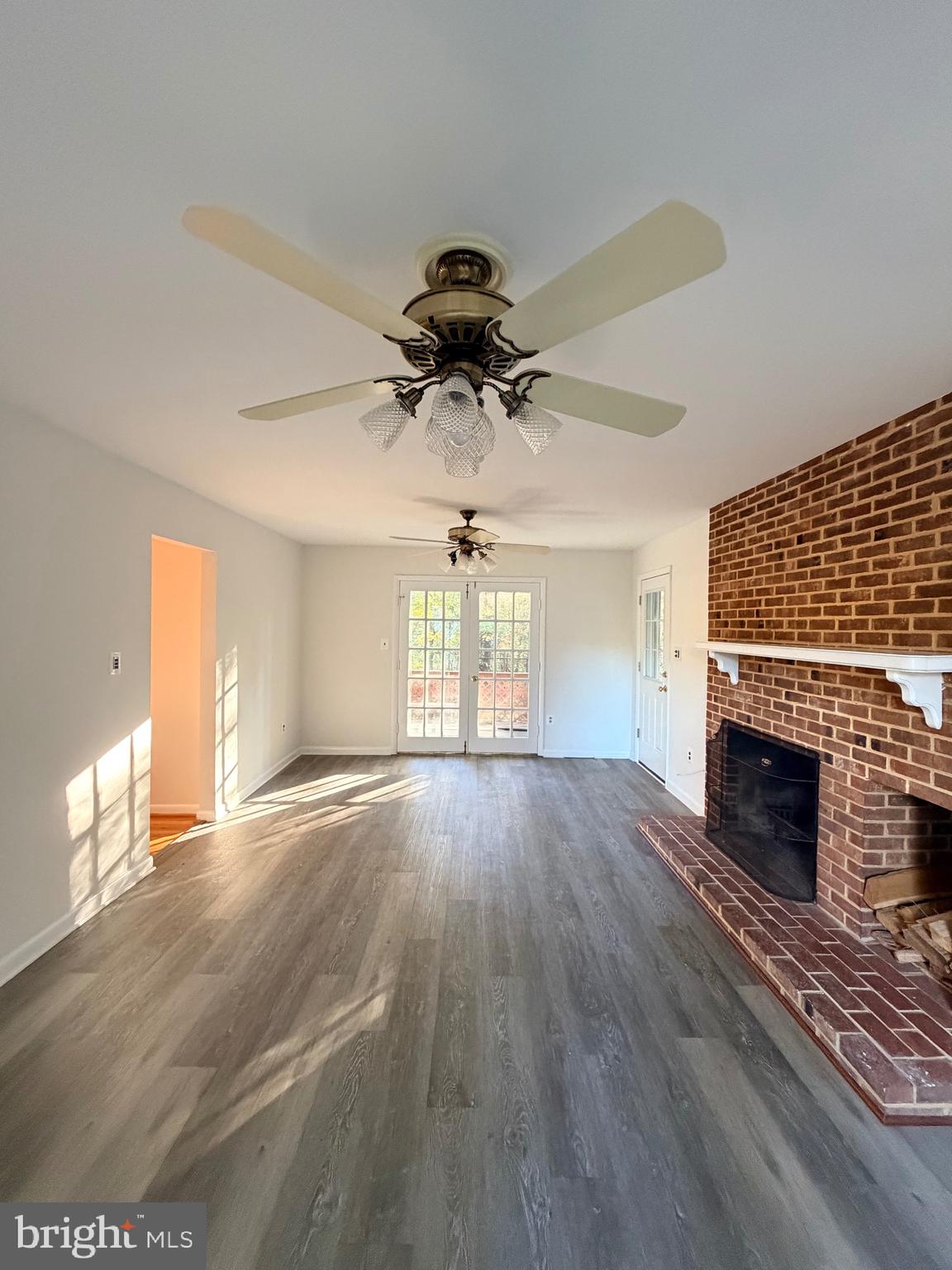 9513 Stevebrook Road Fairfax, VA 22032 - Photo 13 of 37 a view of empty room with wooden floor and fireplace