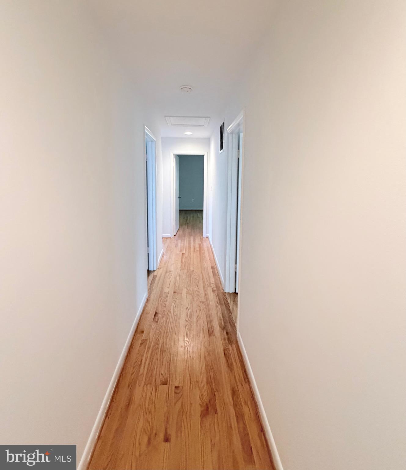 9513 Stevebrook Road Fairfax, VA 22032 - Photo 16 of 37 a view of a hallway with wooden floor