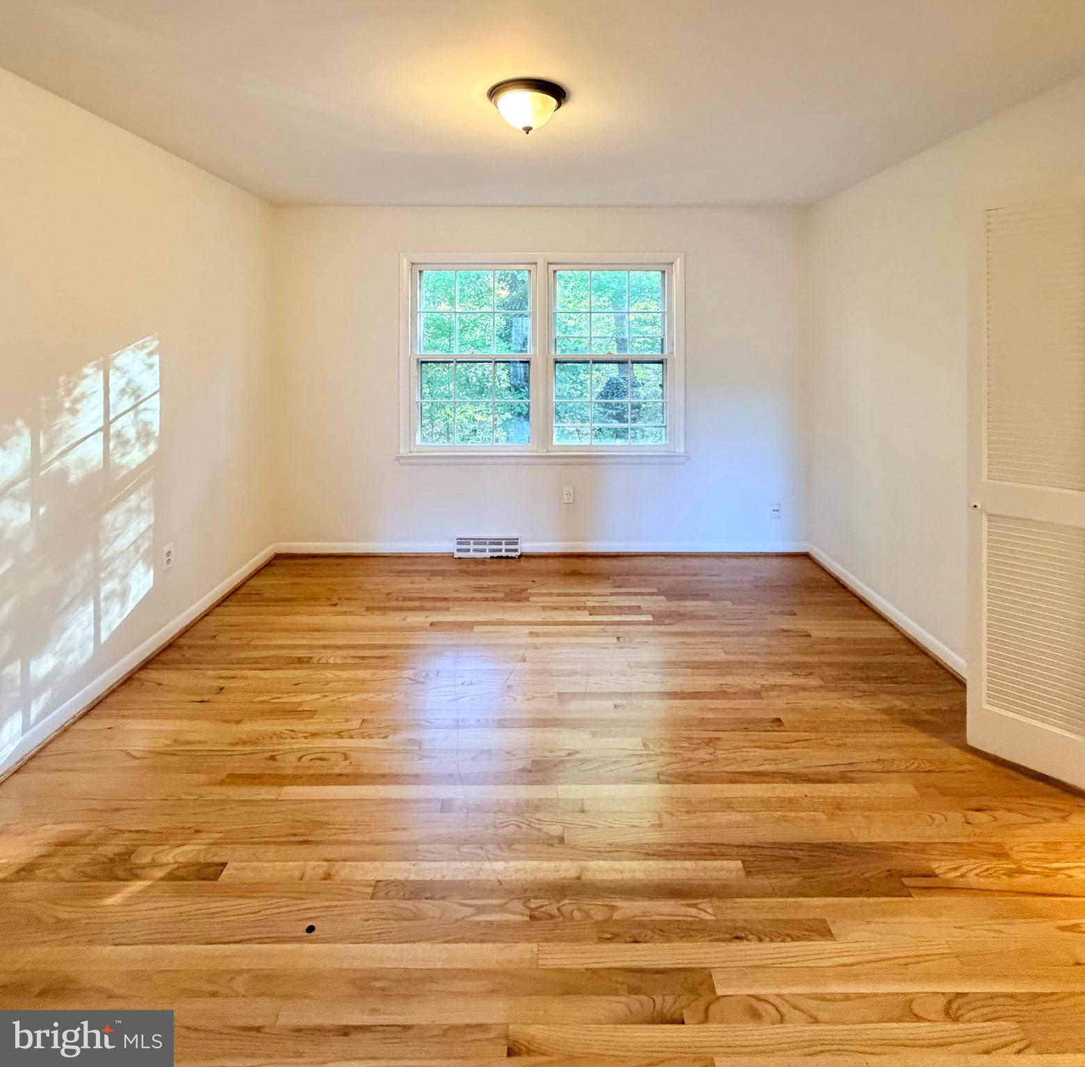 9513 Stevebrook Road Fairfax, VA 22032 - Photo 29 of 37 an empty room with wooden floor and windows