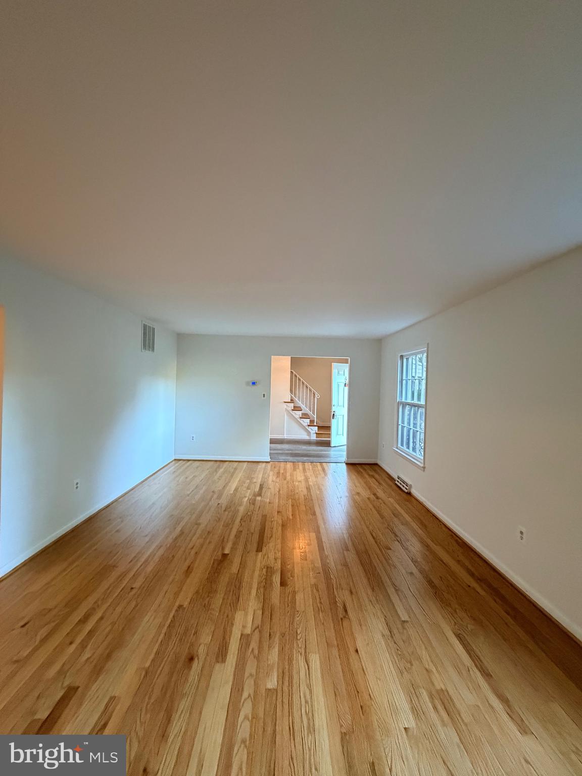 9513 Stevebrook Road Fairfax, VA 22032 - Photo 30 of 37 a view of empty room with window and wooden floor