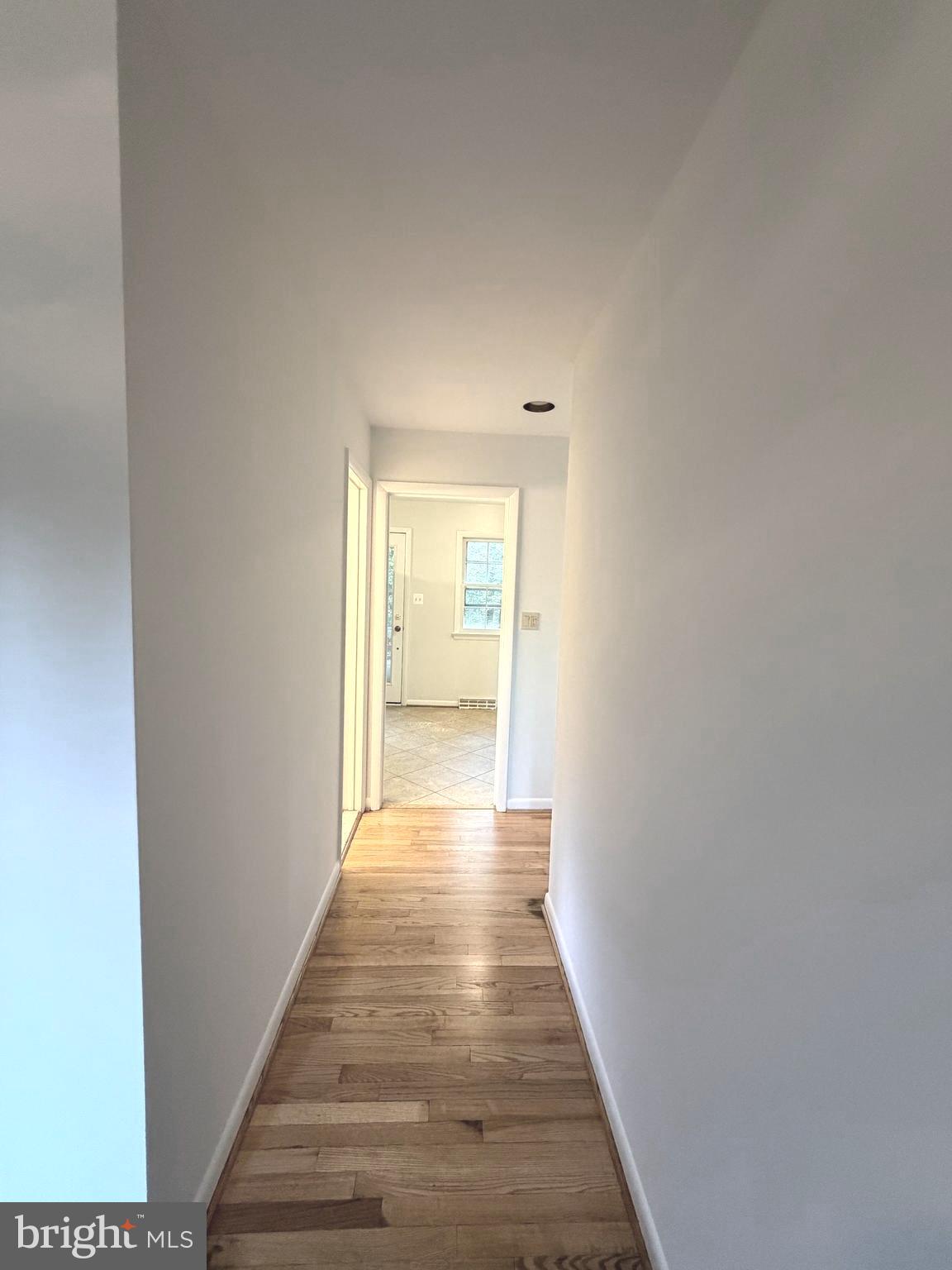 9513 Stevebrook Road Fairfax, VA 22032 - Photo 33 of 37 a view of a hallway with wooden floor