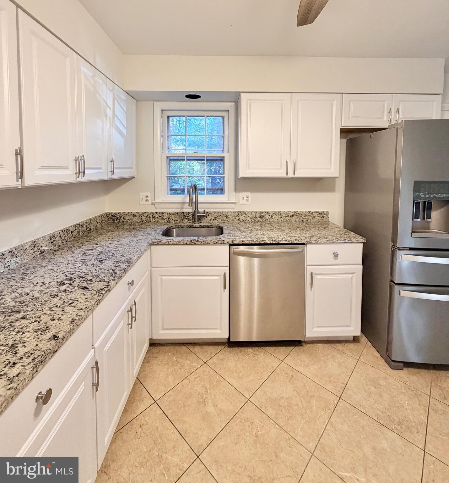 9513 Stevebrook Road Fairfax, VA 22032 - Photo 8 of 37 a kitchen with a stove a sink and a refrigerator