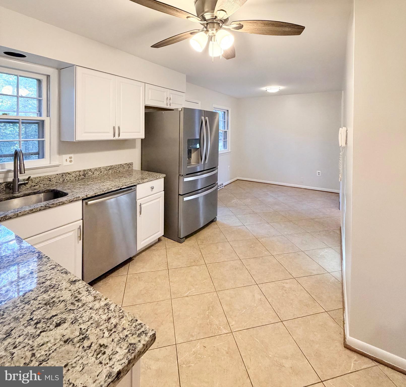 9513 Stevebrook Road Fairfax, VA 22032 - Photo 10 of 37 a kitchen with stainless steel appliances granite countertop a sink and cabinets