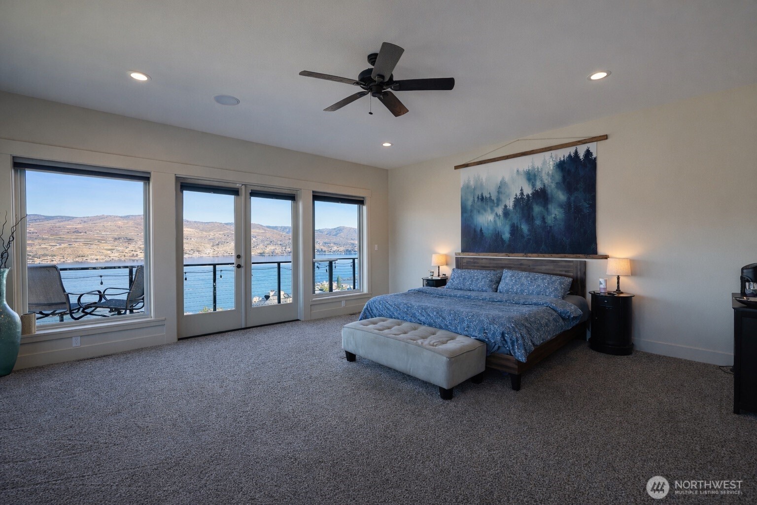149 Clos Chevalle Road Chelan, WA 98816 - Photo 16 of 37 a spacious bedroom with a bed and a large window