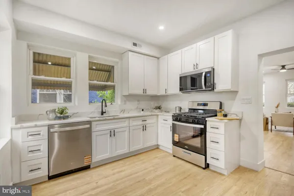 a kitchen with a sink stove and cabinets