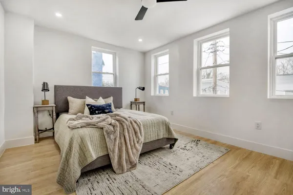a bedroom with a bed and a painting on the wall
