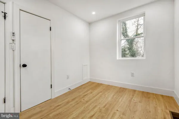 an empty room with a empty space and windows