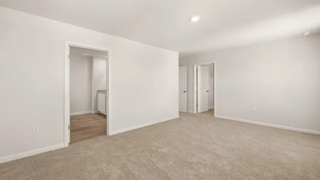 an empty room with closet and a bathroom