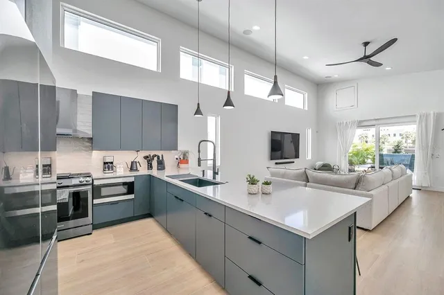 a kitchen with sink stove and cabinets