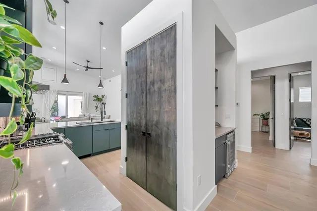 a kitchen with kitchen island granite countertop a refrigerator and a sink