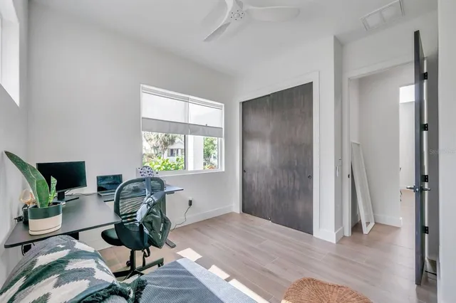 a view of a workspace with furniture and a window