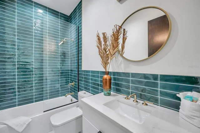 a bathroom with a sink a toilet and mirror